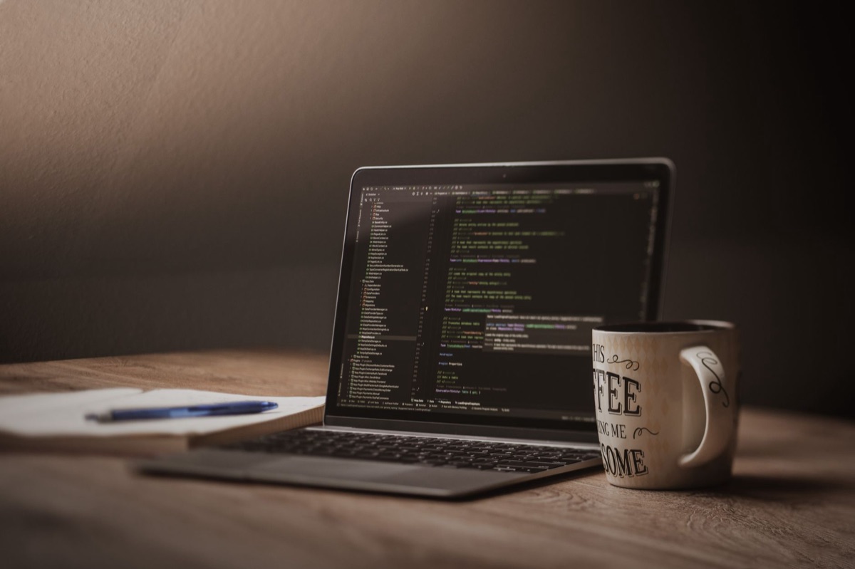 Developer using laptop with code editor open for LLM coding tasks